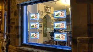 Estate agent window display with rod-powered light pockets